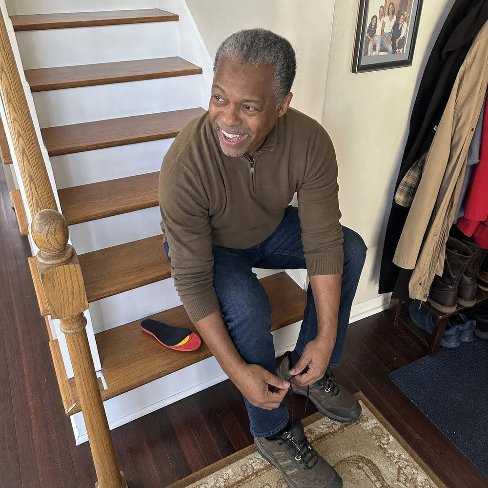Robert laughing while preparing his walking shoes with Ortavio ArcCore insoles