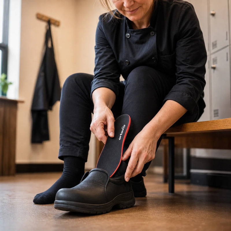 Kitchen worker fitting an Ortavio ArcCore insole into a work shoe