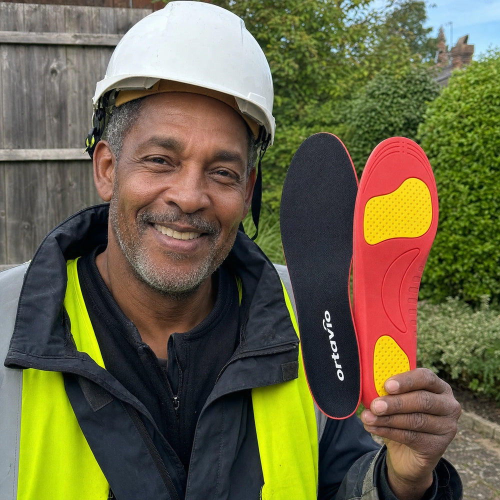 construction worker holding Ortavio ArcCore insoles